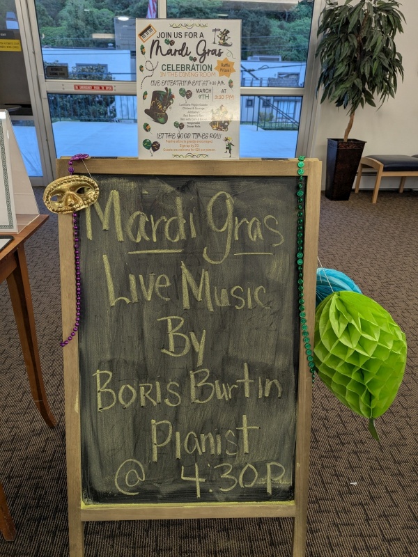 Solo piano performance at a Mardi Gras party